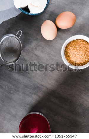 Baking ingredients, preparing dough on dark background from above. Copy space, vertical