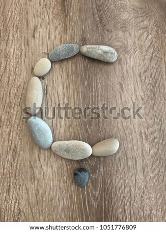 the letter C written in stone