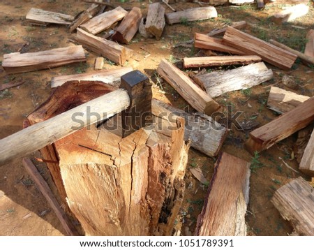Dry firewood and axe. Royalty high quality free stock image of dry firewood with axe or hammer