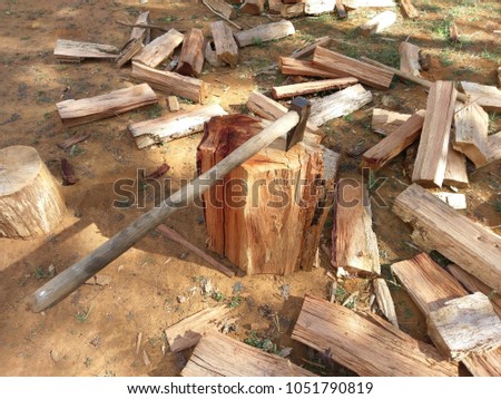 Dry firewood and axe. Royalty high quality free stock image of dry firewood with axe or hammer