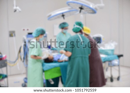 Blurred image background with surgeons team working in operating room.