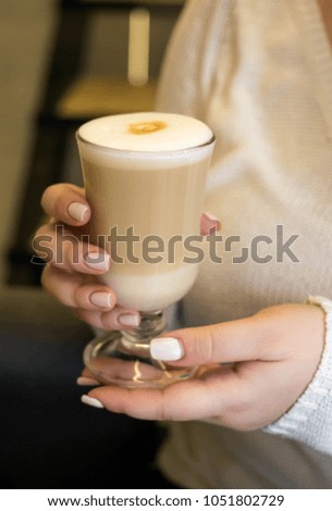 girl's hands with latte 