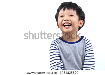 Portrait of a little Asian boy smiling and eye looking up, isolated on white background. Royalty-Free Stock Photo #1051835870