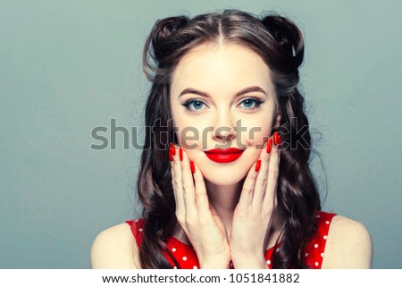 Pin up woman vintage.  Beautiful girl pinup style portrait in retro dress and makeup, manicure nails hands, red lipstick and polka dot dress, surprised face