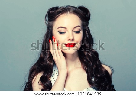 Pin up woman vintage.  Beautiful girl pinup style portrait in retro dress and makeup, manicure nails hands, red lipstick and polka dot dress, surprised face