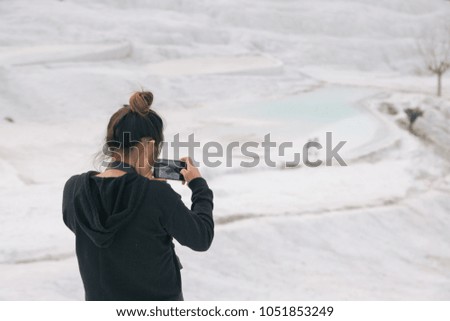 Woman Taking Picture of Natural Travertine Pools and Terraces in Pamukkale, Turkey