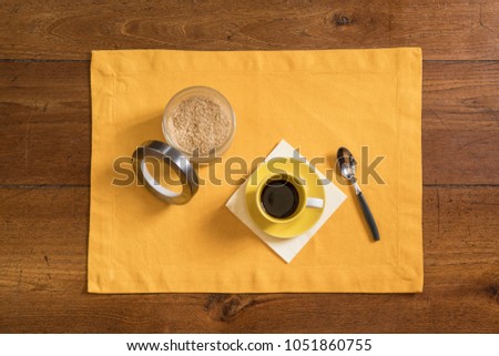 a cup of coffee on the wooden table