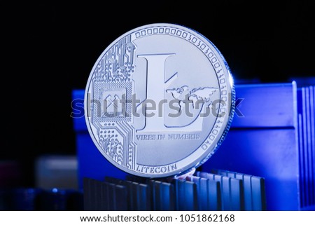 Photo of coin litecoin and processor on blue background