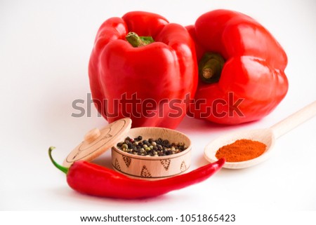 Capsicum,red bell pepper, chili pepper and alispice on the white background and wooden backround. Picture of all types of pepper.