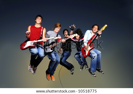 Young crazy gruop of musicians jumping with instruments