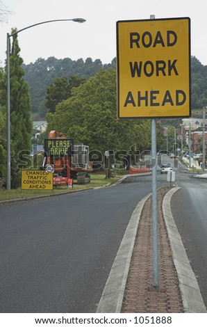 Signs warn drivers of road work ahead.