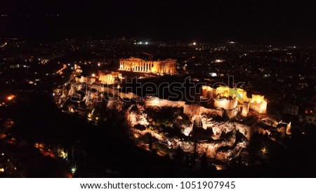Aerial birds eye view night shot taken by drone of iconic Acropolis hill, Propylaia and the Parthenon, Athens historic center, Attica, Greece