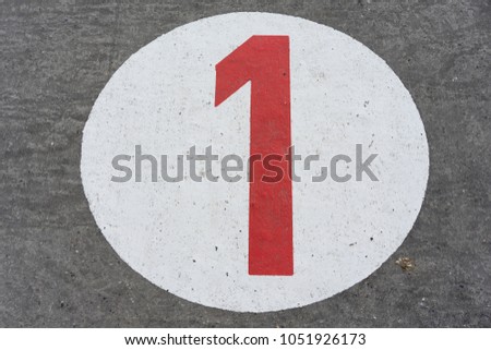 red number one in white circle road sign