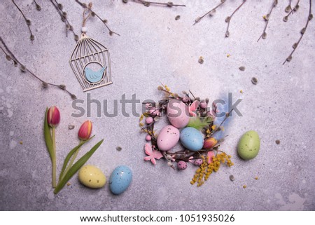 easter eggs and tulips on concrete table