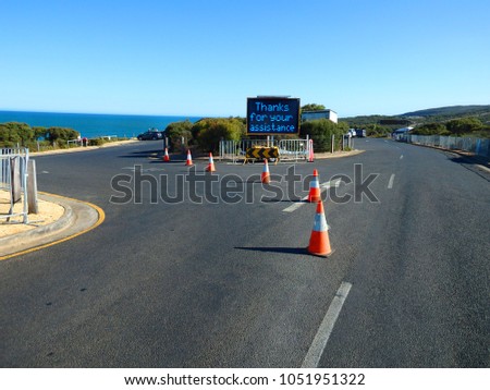 Dynamic Route Guidance System, thank you for your assistance, sign blocking the access to the beach road.
