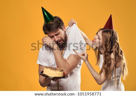 woman scolds a man with a cake, holiday                         