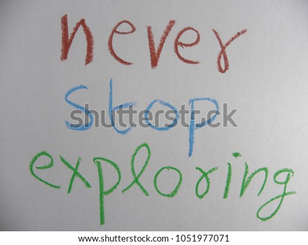 Inspirational quote never stop exploring hand written by colorful oil pastels on paper