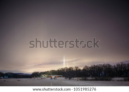 Light pillar landscape at winter night time