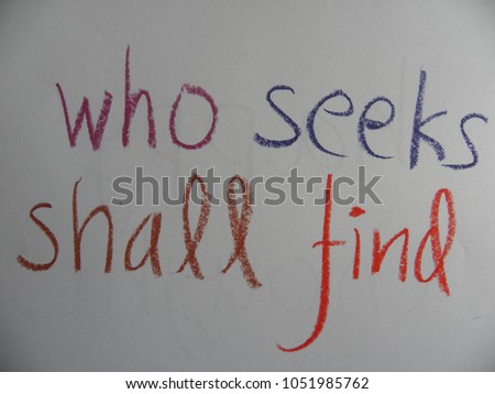 Inspirational quote who seeks shall find hand written by colorful oil pastels on paper