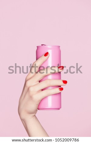 Nails Design. Red Manicure On Woman Hands. Close Up Of Female Hand With Soft Skin And Red Nail Polish Holding Pink Soda Can On Pink Background. High Resolution. Royalty-Free Stock Photo #1052009786