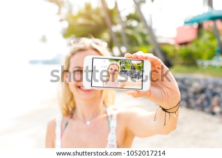 young beautiful woman doing selfie photo with her smartphone