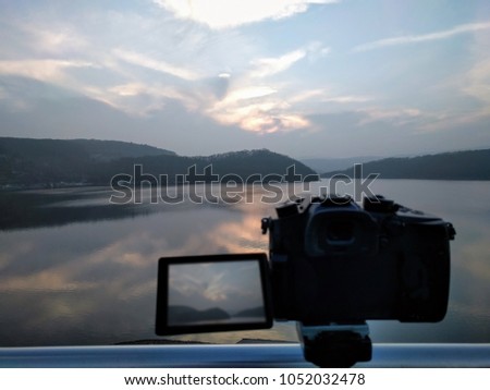 Take creative, bautiful timelapse Pictures or Video of a Sunset with a camera. Landscape with mountains, clouds and trees. Enjoy natural power, breath fresh air and see the beauty of nature. Pure Love