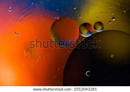Oil drops on water surface abstract background.