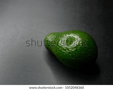 Avocado on dark background. Selective focus and shallow depth of field.
