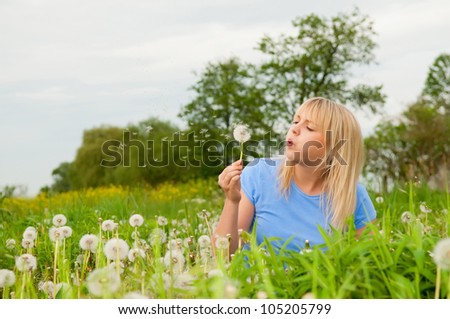 beautiful young blond woman with dandelion
