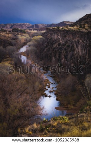 Winding Verde River and giant 175-foot (53-meter) gorge named S.O.B. Canyon with dramatic sky, near Clarkdale, Arizona