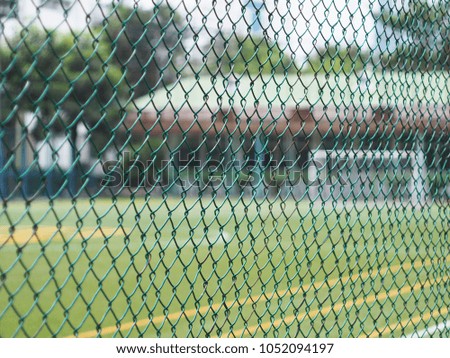 Green net fence at the side of soccer field