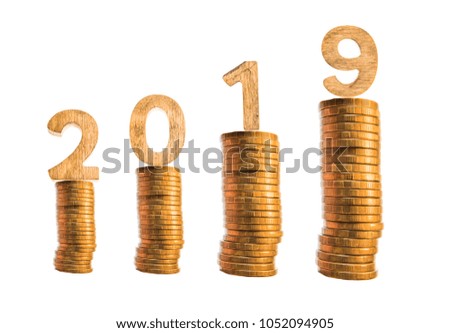 2019 NEW YEAR with stacked golden coins on wooden block. Business and Financial concept. isolated on white background. Golden number 2019 stands on the stacks of coins.