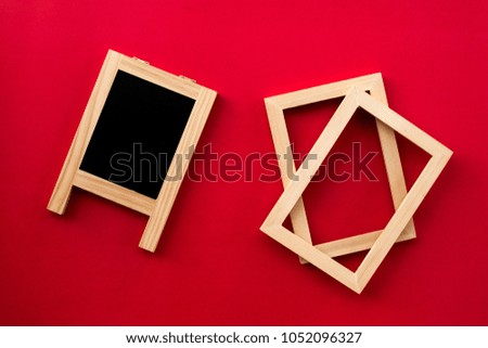 The wooden label chalkboard and picture frames overlay on red wall