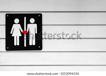Toilet symbol man and woman couple in love on wooden wall. Black and white background color tone