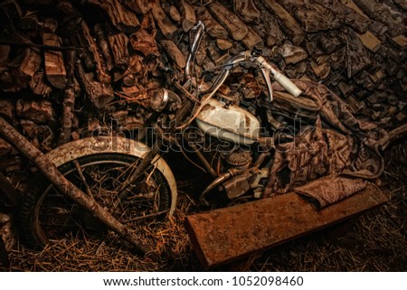 Old rusty abandoned motorcycle, bike, in shed on the farm