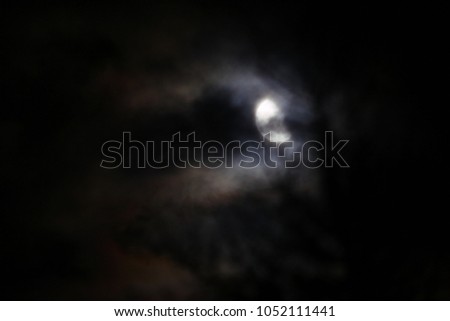 moon hidden behind the soft clouds