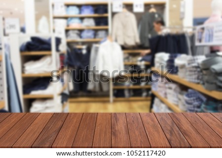 Wooden table in front of a blank background blur abstract of a shopping mall. Can be used for display or editing. products.Mock Your place for display of products.