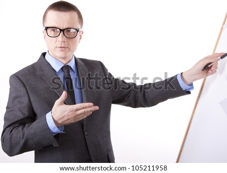 Portrait of a successful young business man pointing with his left hand.