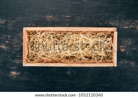 Wooden box for wine or brandy. On a black wooden background. Top view. Copy space for your text.