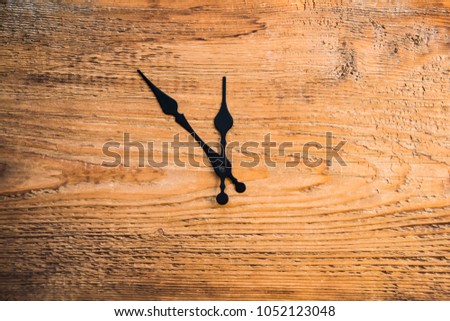 clock made by wooden on the brown wall . wooden wall and copy space.Wooden round wall watch with owl toy - clock