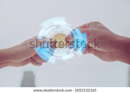 Businessman gives the bitcoin man.selective focus.Businessman giving golden bitcoin to another man. two hands exchanging cryptocurrency.