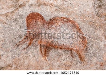 a drawing of an ancient mammoth on a cave wall, made with ocher. history. archeology.