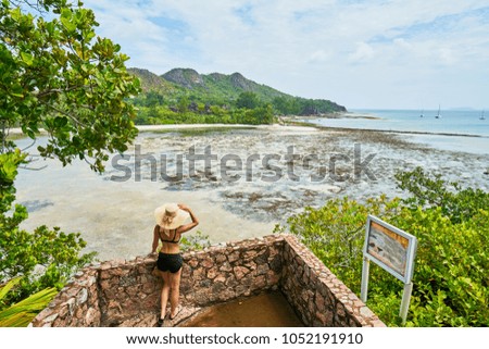 Woman tourist explores Curieuse island coastal trail to Anse St. Jose beach. Seychelles islands
