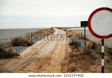 Secret road with closed gate and restrictive traffic signs. Salt Lake Elton
