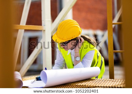 Confident Female Engineer or Architect Working at Construction Plan.