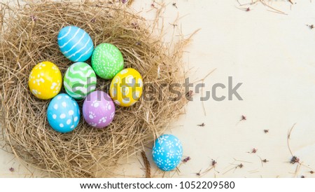 Easter holiday background with Easter eggs in the nest and spring flowers. Picture is with copy space.