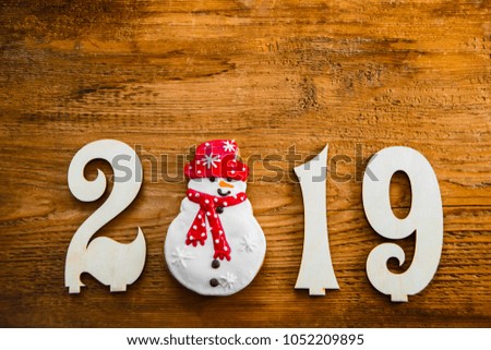homemade gingerbread cookies on a rustic Christmas background.Christmas background decorations with gift star and snowman on wooden table with copy space. 2019 happy new year