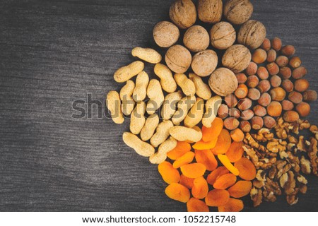  Nuts lie in a circle on a gray table for a healthy lifestyle