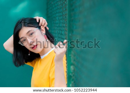 Portrait of beautiful asian girl pose for take a picture,Lifestyle of teen thailand people,Modern woman happy concept,Tennis course, pastel tone