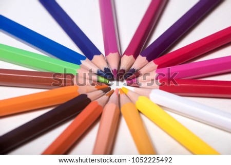 Several colored pencils. Some of them are macro or have gaps so that the client can include their own content